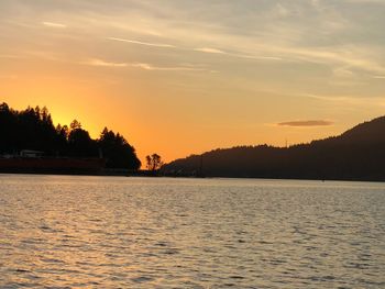 Scenic view of lake against orange sky