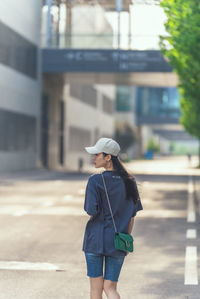 Rear view of woman walking on street