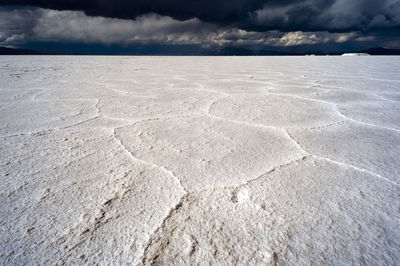 View of salt beach under cloudy sky