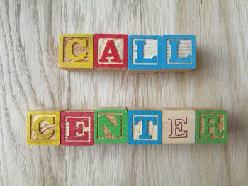 Directly above shot of call center text made from toy blocks on table