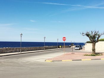 Empty road with trees in background