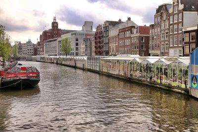 Bridge over canal amidst buildings in city