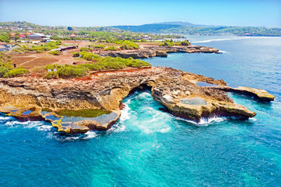 High angle view of bay in sea against sky