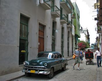 People in car on city street