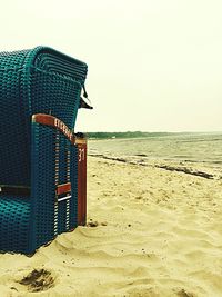 Lifeguard hut on beach against clear sky