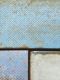 Directly above view of blue metallic walkway in factory