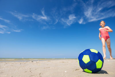 Boy playing with ball on beach