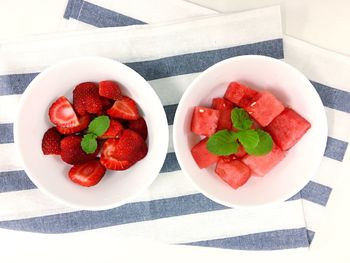 High angle view of fruits in bowls on table