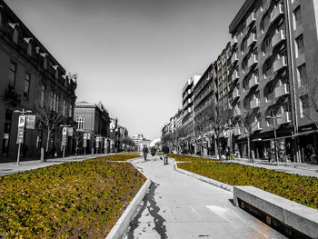 Panoramic view of road amidst buildings against clear sky