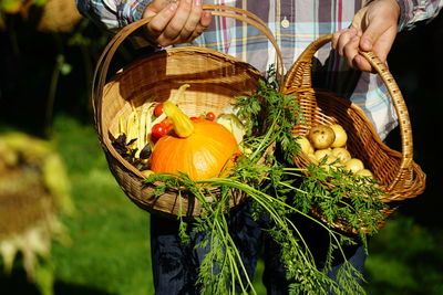 Midsection of man selling food in basket