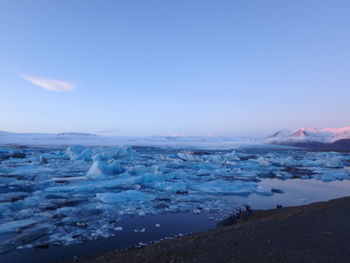 Scenic view of frozen lake against sky during winter