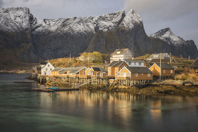 Scenic view of lake and buildings against sky