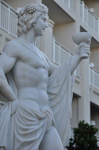 Low angle view of statue against historic building