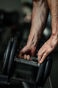 Cropped hands of man exercising in gym