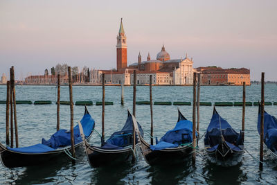 Gondolas moored on grand canal at sunset