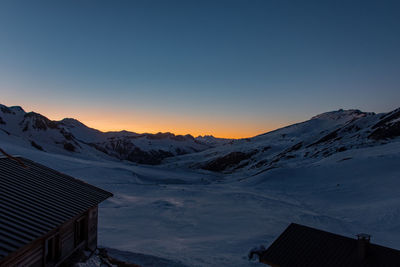 Scenic view of snowcapped mountains against clear sky during winter