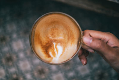 Cropped hand having coffee