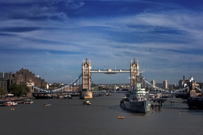 Boats in river with city in background