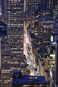 Aerial view of city lit up at night