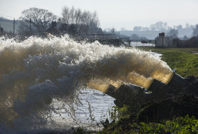 Scenic view of river against sky during winter