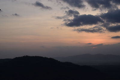 Scenic view of silhouette mountains against sky at sunset