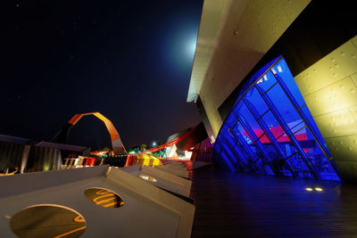 Illuminated city against clear sky at night