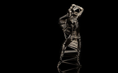 Low angle view of person standing against black background