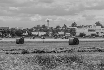 Hay bales on field against sky