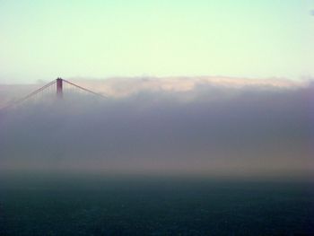 Suspension bridge covered with smoke