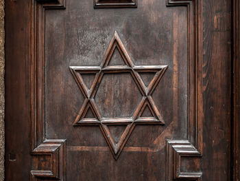 Symbol of star of david on old synagogue wooden door