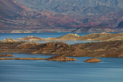 Scenic view of sea and mountains against sky