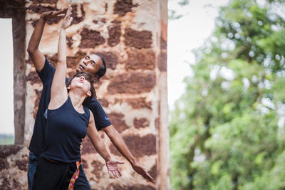 Woman standing on tree trunk