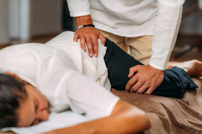 Therapist stretching womans leg. shiatsu massage.