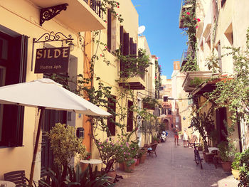 Narrow alley amidst buildings in city against sky