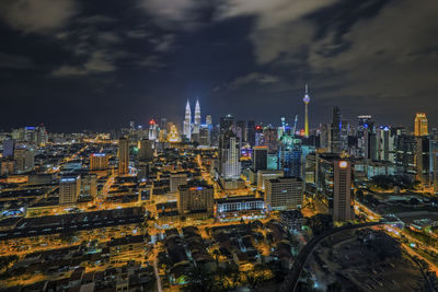 Aerial view of city lit up at night