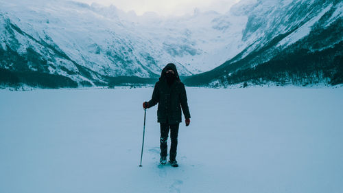 Full length of person standing on snowcapped mountain