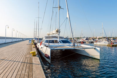 Sailing yachts moored on a pier in a harbour on baltic sea. nautical vessel for charter