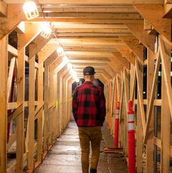 Rear view of man standing on corridor