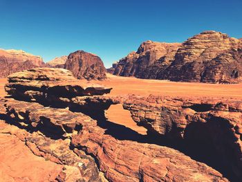 Scenic view of rocky mountains against clear blue sky