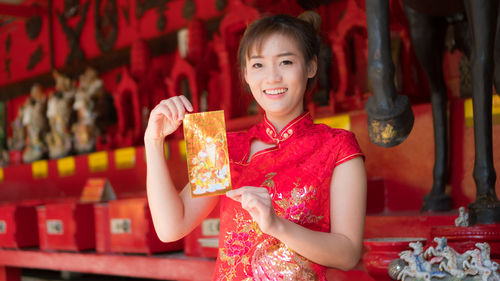 Portrait of young woman holding red wine