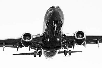 Low angle view of airplane against clear sky