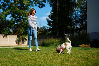 Rear view of woman standing on grassy field