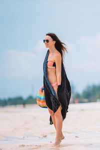 Young woman standing at beach