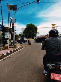 Rear view of people on street in city