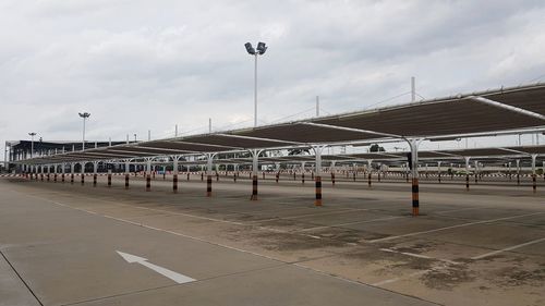 Empty parking lot at airport against sky