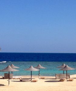 Scenic view of beach against blue sky