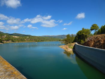 Scenic view of reservoir at riudecanyes against sky