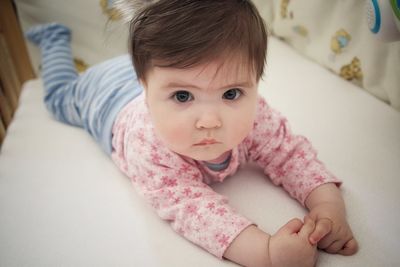 Portrait of cute girl sitting at home