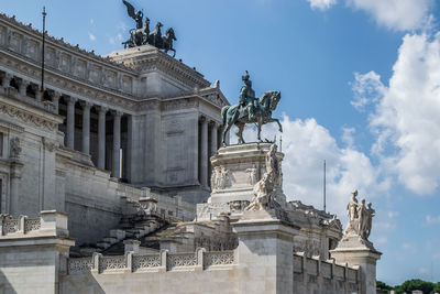 The altare della patria, altar of the fatherland. a museum in rome, italy. statue against blue sky.