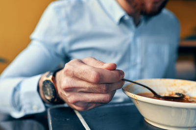 Midsection of man preparing food